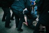 A police man tackles an attacker.