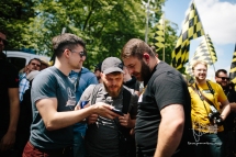 Martin Sellner shows other activists a video on smartphone