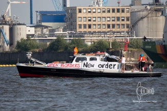 Boat with pro-refugee banner