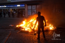 Man standing in front of burning barrier.